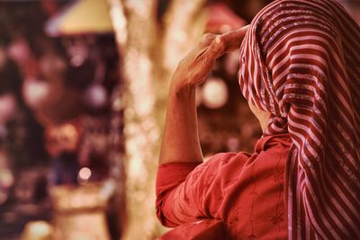 Rear view of woman wearing striped headscarf