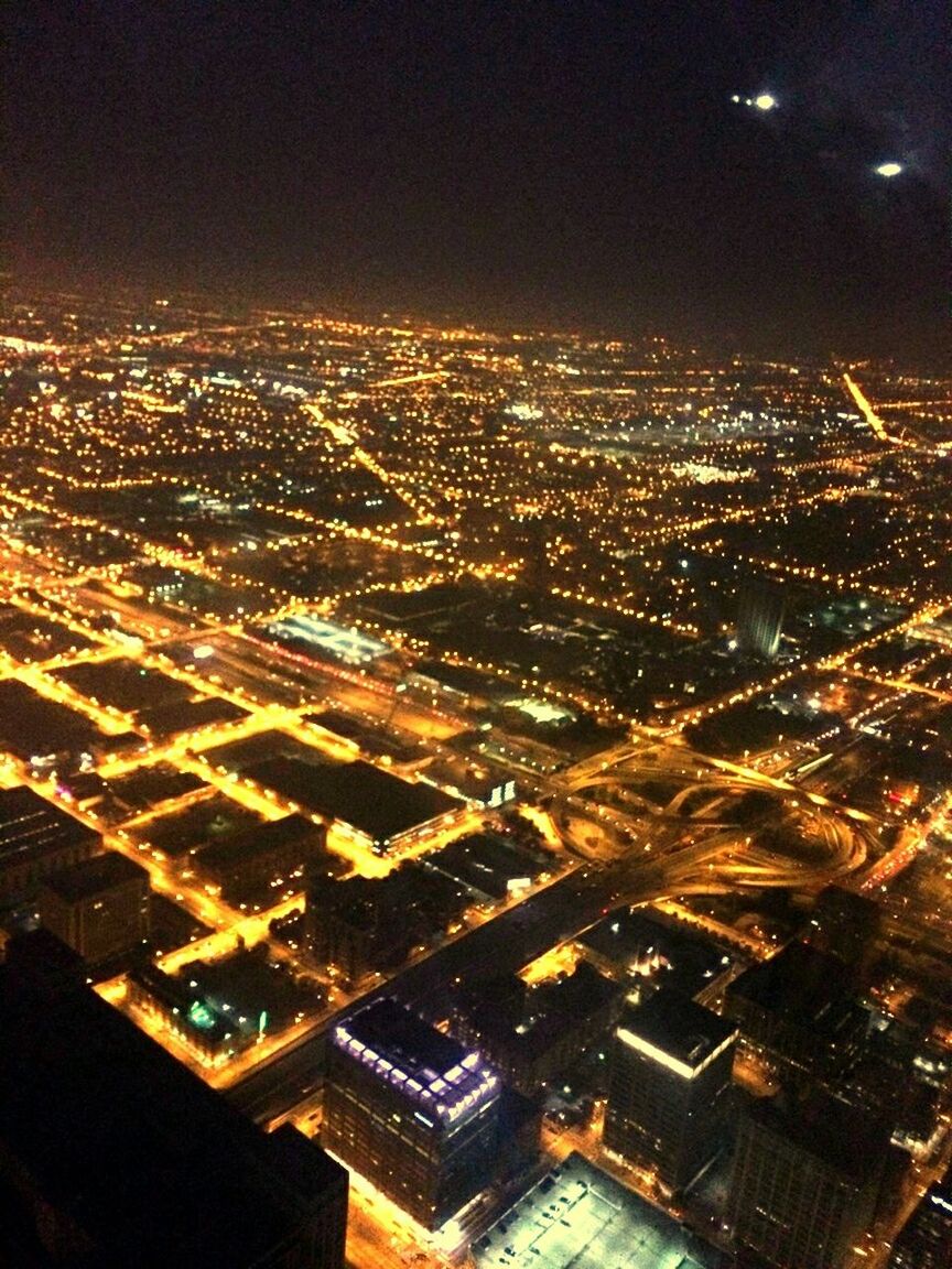 illuminated, cityscape, night, city, building exterior, architecture, built structure, crowded, high angle view, aerial view, residential district, residential building, city life, residential structure, sky, no people, outdoors, skyscraper, urban scene, community