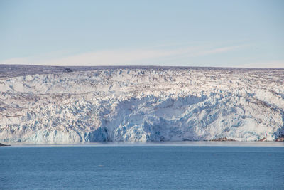 Scenic view of sea and mountains against sky