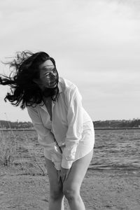 Midsection of woman standing against sky