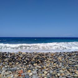 Scenic view of sea against clear blue sky