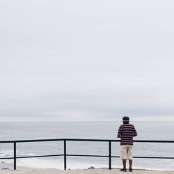 Rear view of man standing on beach