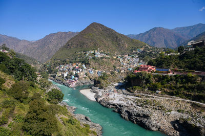 Scenic view of lake and mountains against clear sky