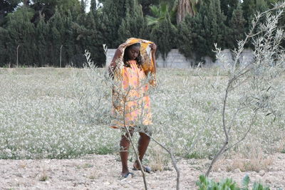Full length of woman standing on field