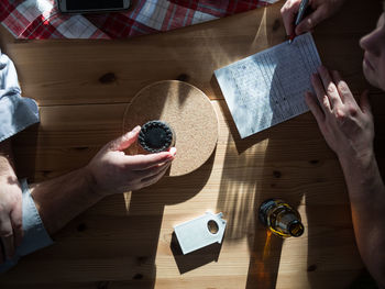 High angle view of people playing dice game on table