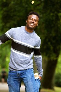 Portrait of smiling young man standing outdoors