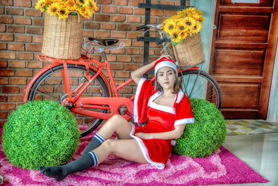 Full length portrait of woman sitting in yard