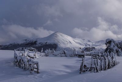 Scenic view of snow covered mountains against sky