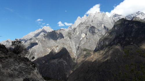 Scenic view of mountains against cloudy sky