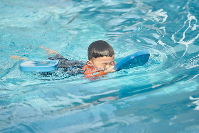 Portrait of boy swimming in pool