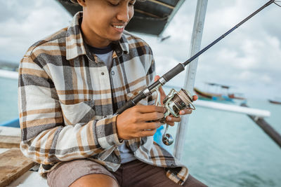 Low angle view of young man using mobile phone