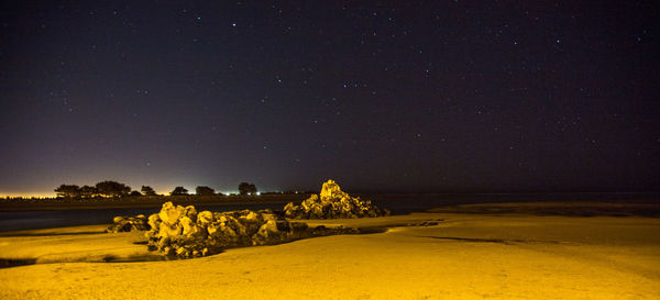 Scenic view of landscape against sky at night