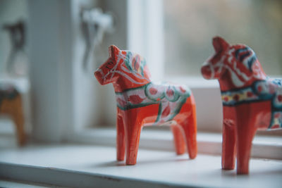 Close-up of figurines on window sill