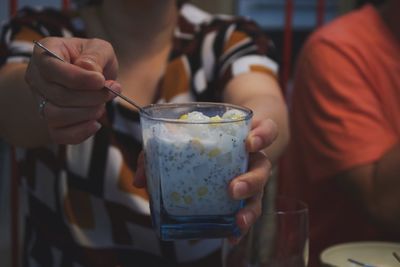 Close-up of woman holding dessert at night