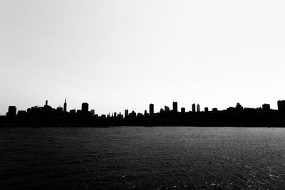 Silhouette of city against clear sky