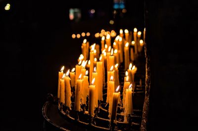 Close-up of lit candles in temple