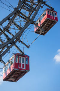 Low angle view of crane against clear blue sky