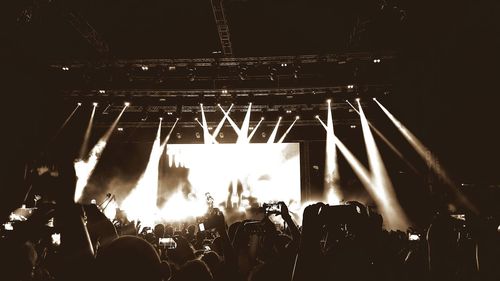 People enjoying music concert at night