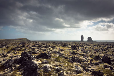 Scenic view of landscape against cloudy sky