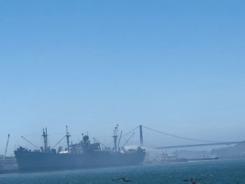 Bridge over sea against clear sky