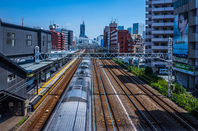 High angle view of railroad tracks amidst buildings in city