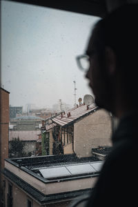 Portrait of wet glass window in city