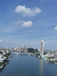Buildings in city against cloudy sky