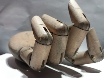 Close-up of wooden figurine hand on table