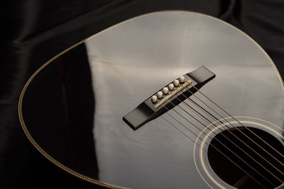 High angle view of guitar on bed