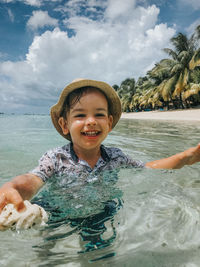 Portrait of boy swimming in ocean