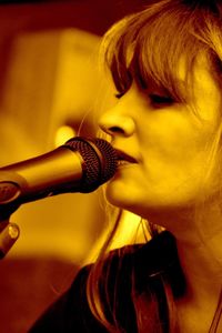 Close-up of woman singing on microphone