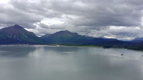 Scenic view of lake and mountains against sky