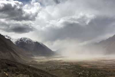 Scenic view of landscape against cloudy sky