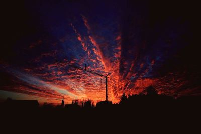 Low angle view of silhouette trees against sky at night