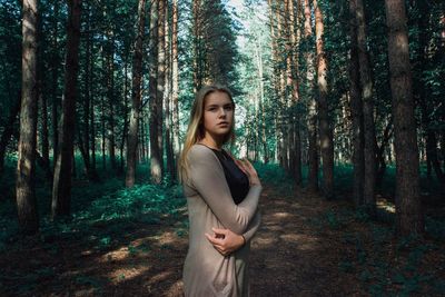 Woman standing in forest
