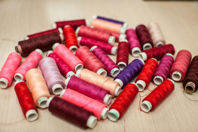 High angle view of colorful thread spools on table