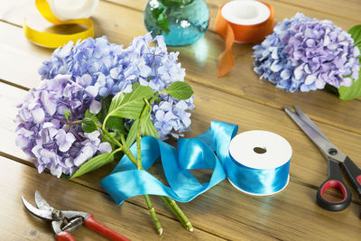 High angle view of flowers with ribbons and cutting tools