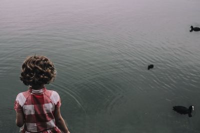 High angle view of girl standing by lake