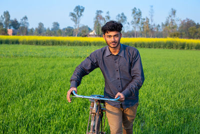 Young man standing in field