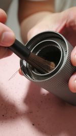 Cleaning a coffee bean grinder up close