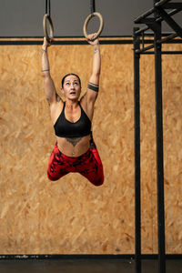 Portrait of young woman exercising in gym