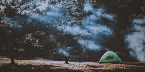 Tent on landscape against sky