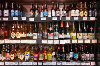 Multi colored bottles on display at market stall