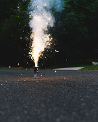 View of firework display on street at night