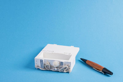 High angle view of book on table against blue background