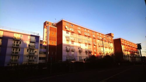 Buildings against clear sky at sunset