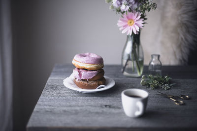 Donuts and coffee cup on table at home