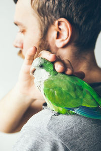 Close-up of man holding a bird