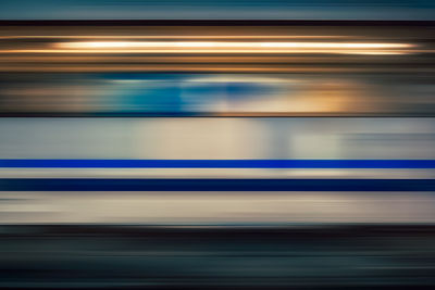 Blurred motion of train at railroad station