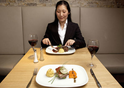 Businesswoman eating at restaurant in a luxury hotel